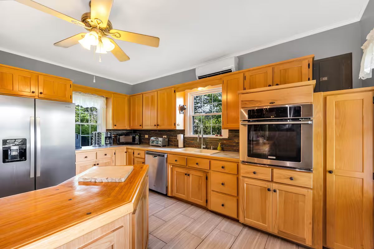 Cass House full kitchen with honey oak cabinets, butcher block island